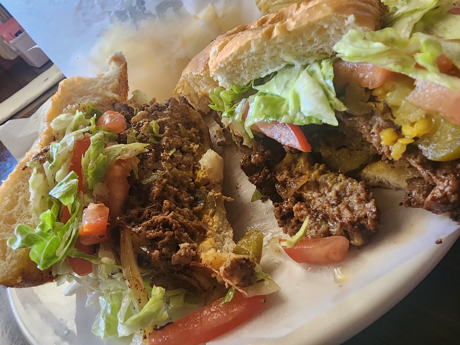 Torta sandwich piled with seasoned meat, lettuce, and tomato